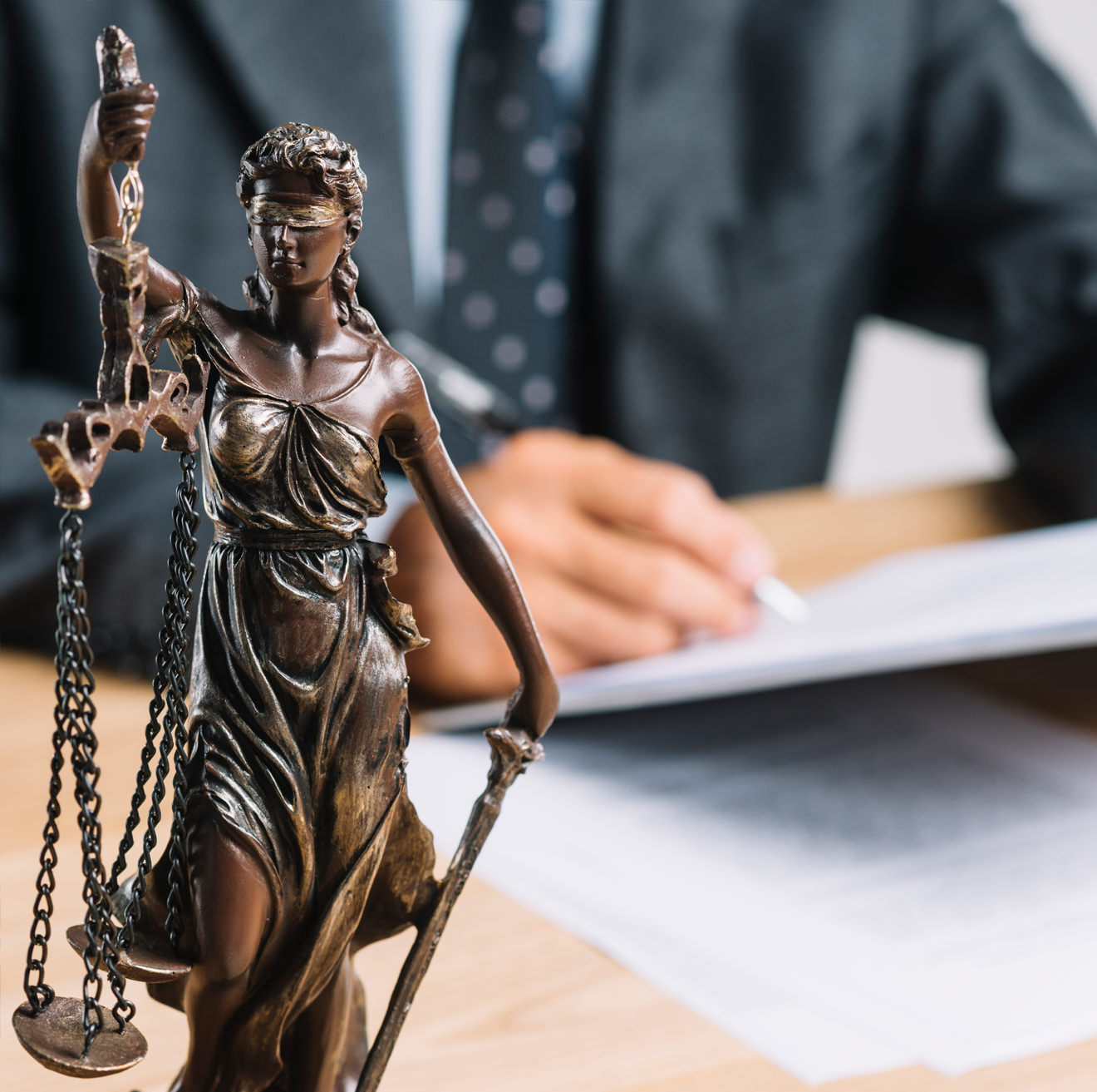 Lady Justice statue on an attorney's desk