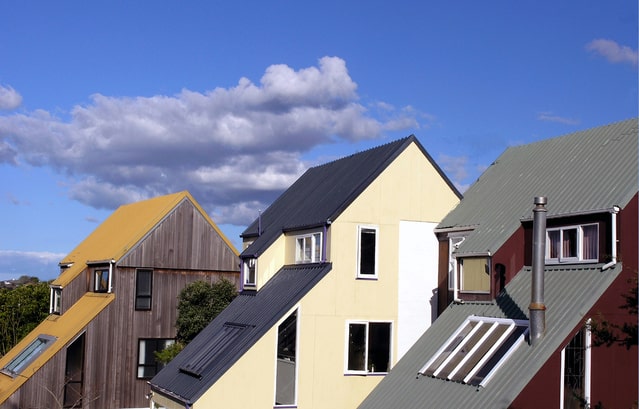 Row of suburban houses under a blue sky