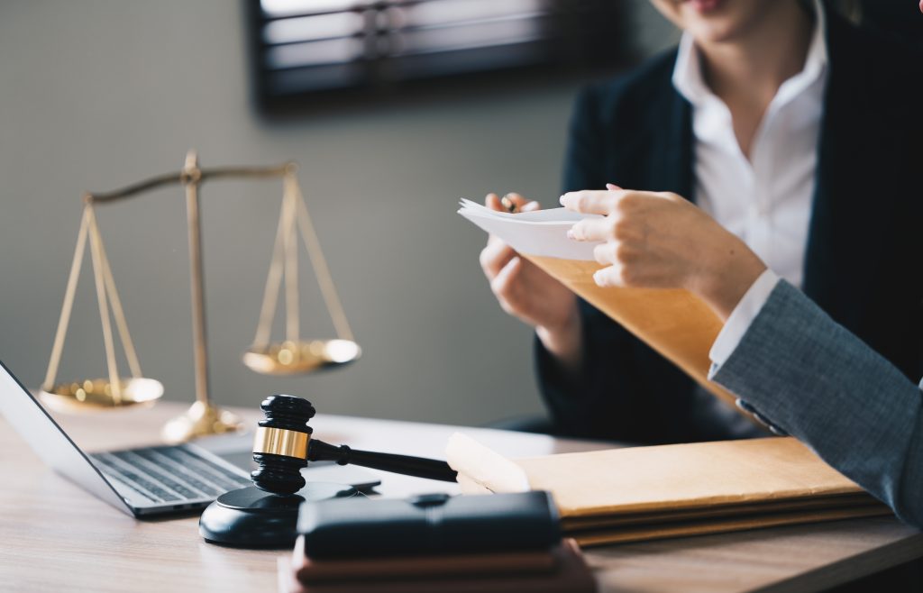 Attorney at a desk with scales of justice and a gavel