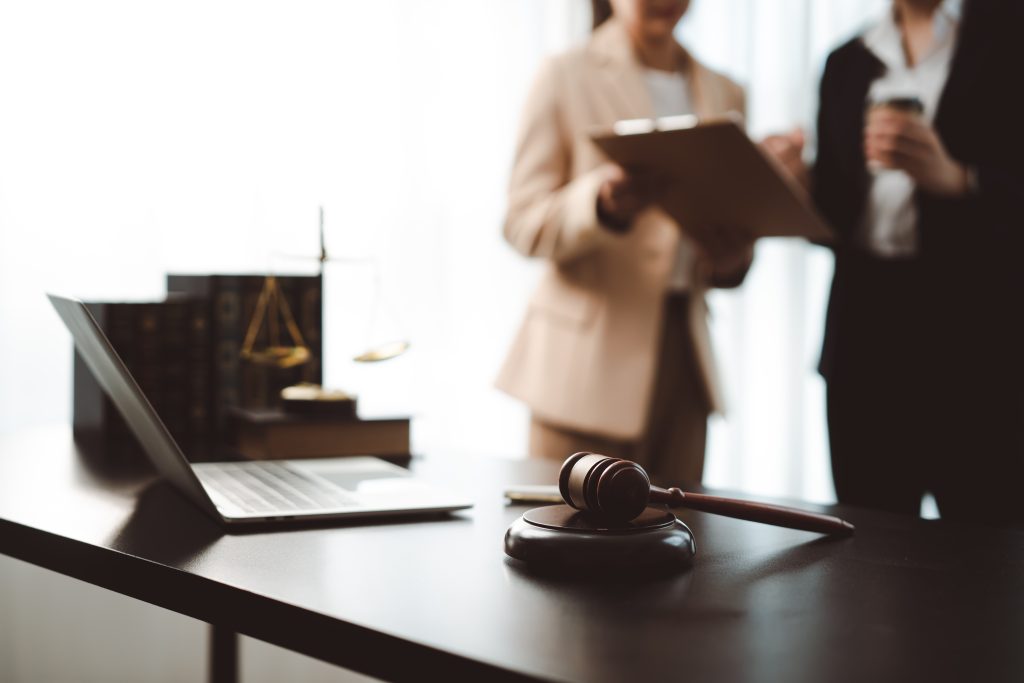 Legal team discussing a case with a gavel on the desk