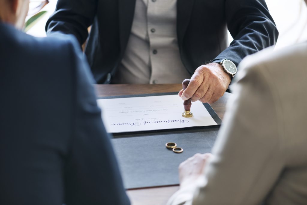 Attorney and client reviewing divorce papers at a desk